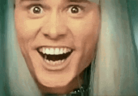 a close up of a person 's face with a surprised look on his face .