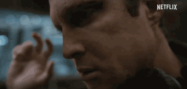 a close up of a man 's face with a netflix logo above him