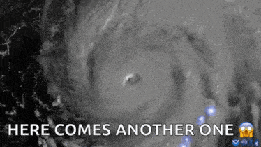 an aerial view of a hurricane with the words `` here comes another one ''