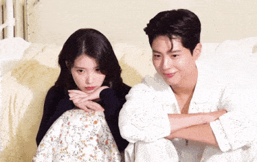 a man and a woman are sitting next to each other