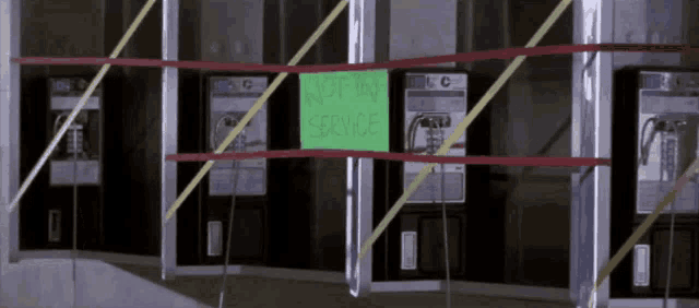 a sign that says " not in service " is taped to a wall