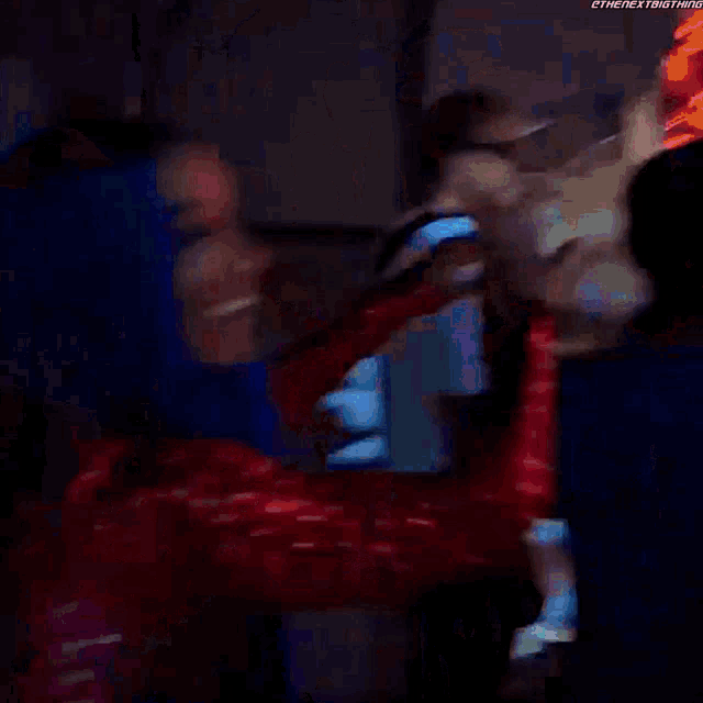 a woman with blue hair is dancing with a man in a dark room .