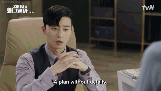 a man sits in a chair and says " a plan without details . "