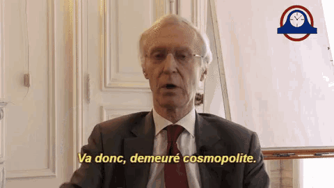 a man in a suit and tie is saying va donc demeure cosmopoliste