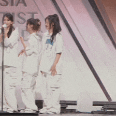 a group of women standing on a stage with a sign behind them that says ' sta ' on it