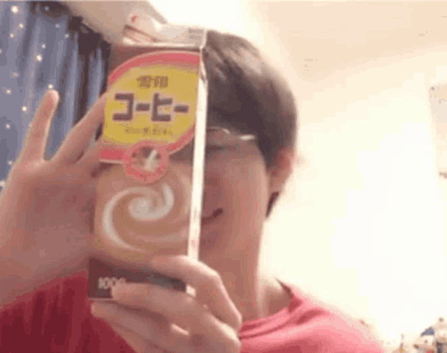 a man is holding a carton of coffee that says 1000