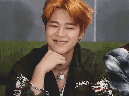 a man with orange hair is wearing a jacket that says s. navy on it