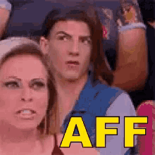 a man and a woman are sitting in a crowd with the word aff written in yellow letters