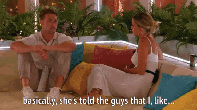 a man and a woman are sitting on a couch and the man says basically she 's told the guys that i