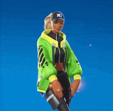 a woman in a green jacket and black pants is wearing a black hat with the letter x on it