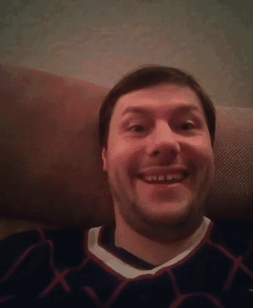 a man laying on a couch with his eyes closed wearing a jersey that says x on it