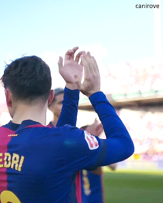a soccer player wearing a number 2 jersey applauds