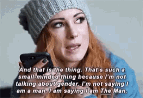a woman in a knitted hat is holding a cell phone and says " and that is the thing "