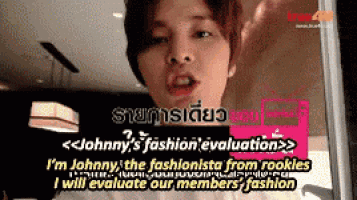 a man is standing in front of a sign that says i 'm johnny the fashionista from rookies