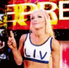 a woman wearing a white tank top that says liv on it