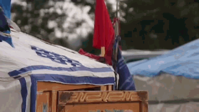 a close up of a tent with a red flag hanging from the roof .
