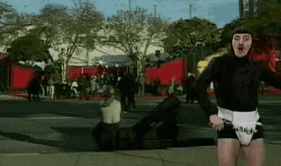 a man in a costume with the word army on his belt is running down a street