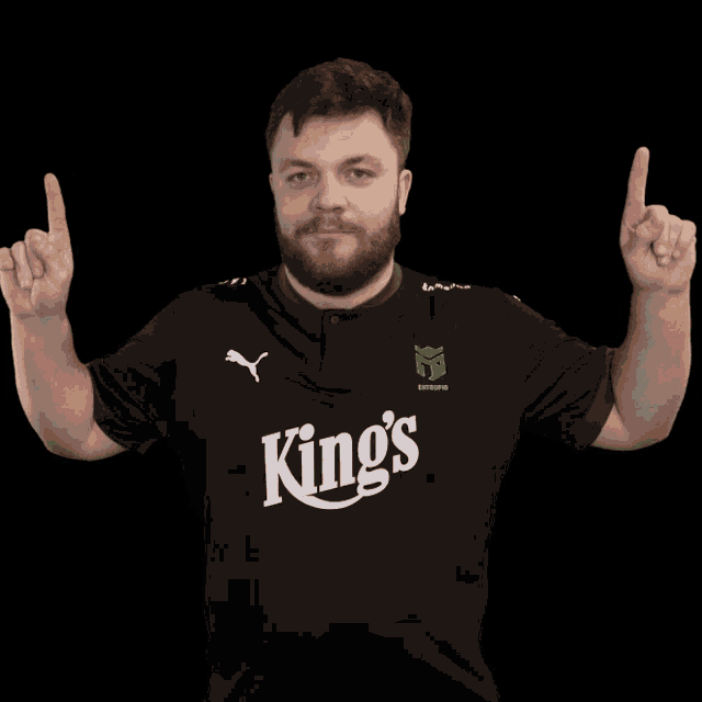 a man wearing a black shirt with king 's written on it