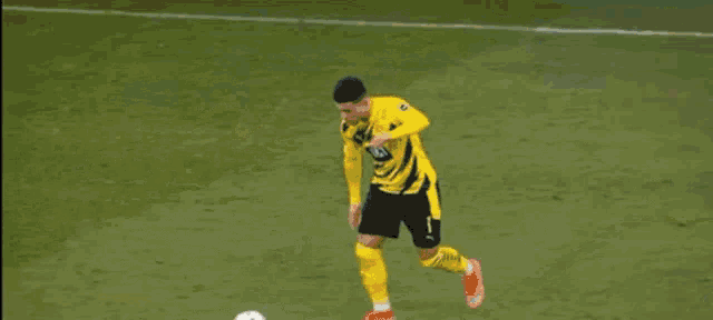a soccer player wearing a number 23 jersey is laying on the ground