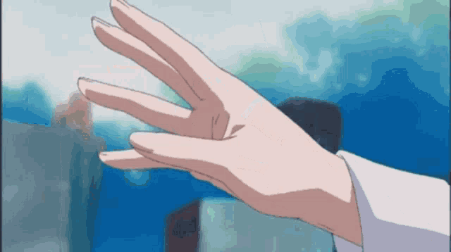 a close up of a person 's hand reaching out towards something
