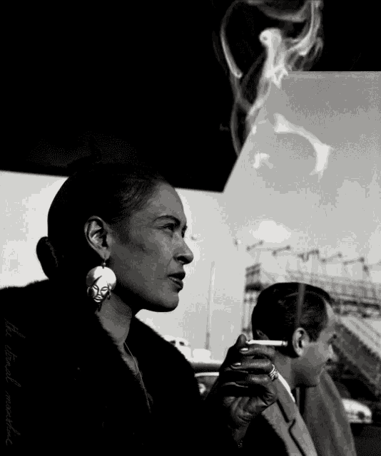 a black and white photo of a woman smoking a cigarette and a man smoking