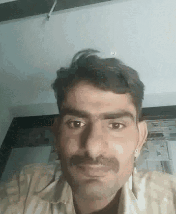 a man with a mustache is looking at the camera with a serious look on his face .