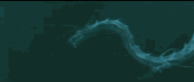 a dragon is swimming in the water and looking at the camera .