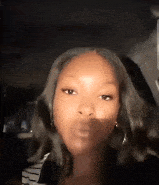 a close up of a woman 's face with a shadow on it .