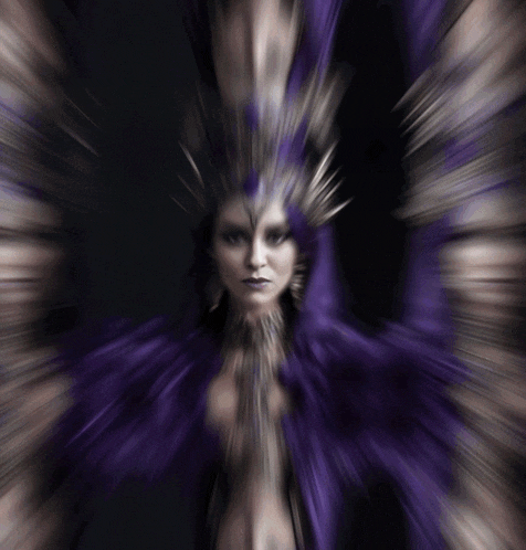 a blurry picture of a woman with a purple feathered headpiece