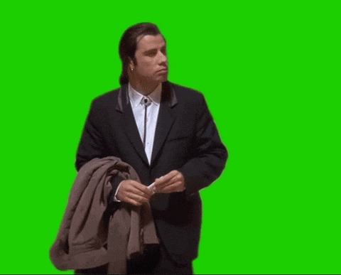 a man in a suit holds a jacket over his shoulder