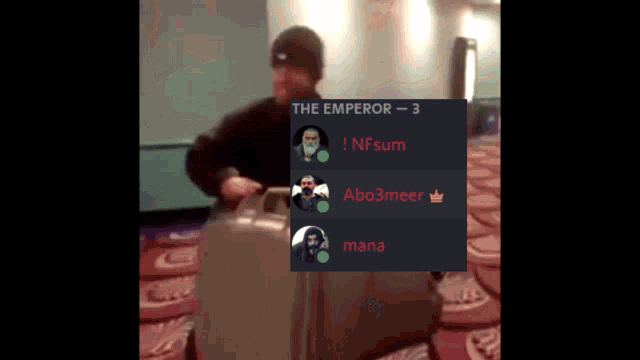 a man holding a suitcase with the emperor written on the bottom