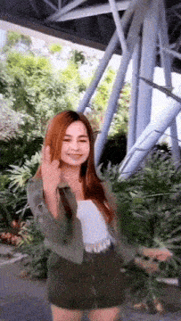a woman with long red hair is giving a middle finger