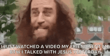 a man with long hair and a beard is talking to jesus on a video .