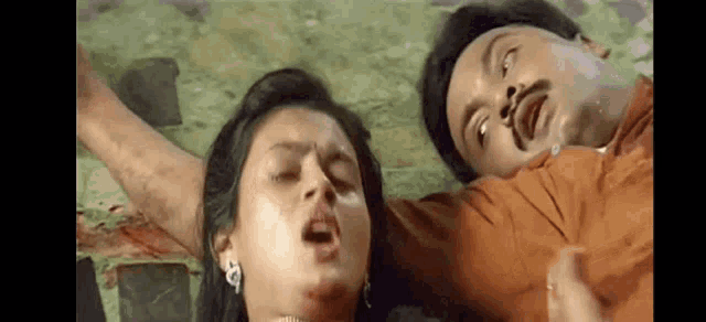 a man and a woman are laying on the floor .