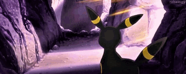 a black and yellow pokemon is standing in a cave .
