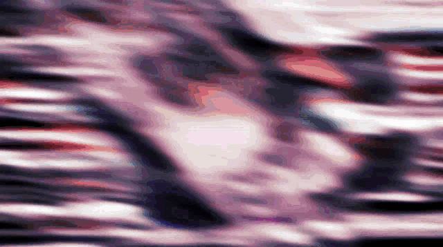 a blurred image of a person 's face with a red white and blue background