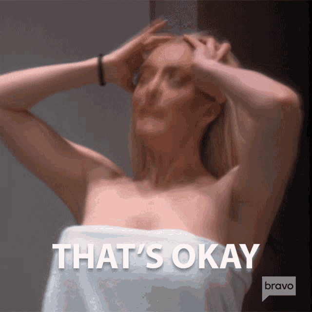 a woman wrapped in a white towel with the words that 's okay on the bottom