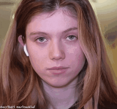 a close up of a woman 's face with the words subscriber marinaskiwi written below her