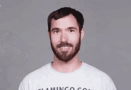 a man with a flamingo golf shirt on is being sprayed with water
