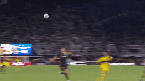 a blurry picture of a soccer game with a few players in yellow