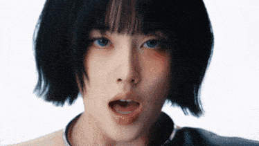 a close up of a girl 's face with her mouth open