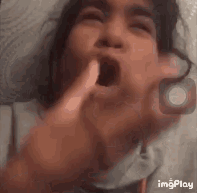 a close up of a person 's face with the word imgplay at the bottom right