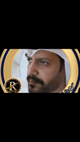 a man with a beard is in a gold and blue circle with the letter k on it