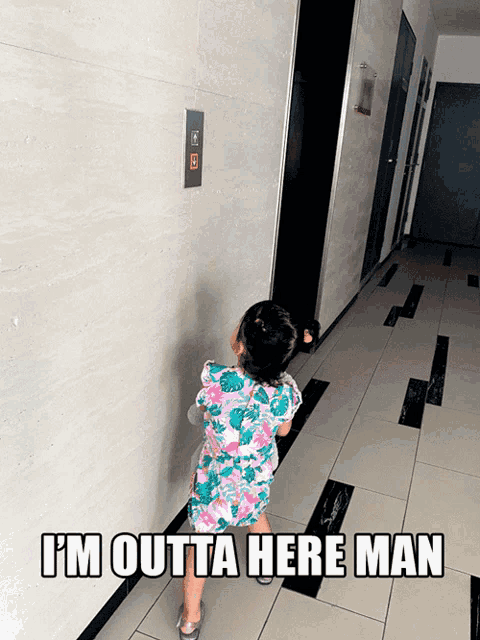 a little girl standing in a hallway with the words i 'm outta here man