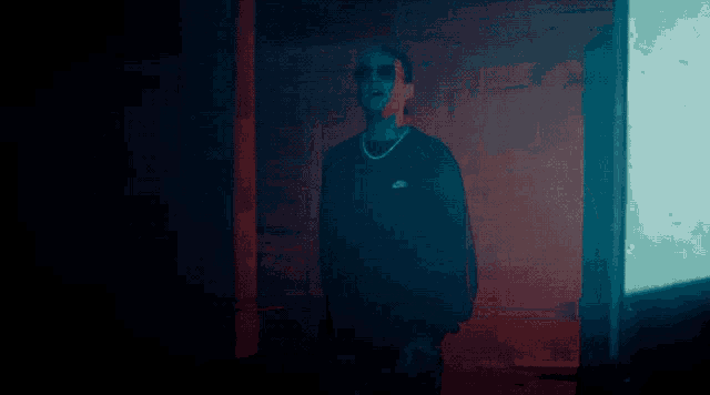 a man wearing sunglasses and a nike sweatshirt