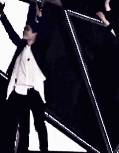 a couple of men are hugging each other on a stage in front of a star .