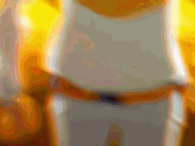 a blurred image of a person 's torso with a white shirt on