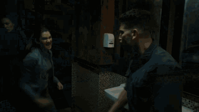 a blurry picture of a man fighting another man in a bathroom