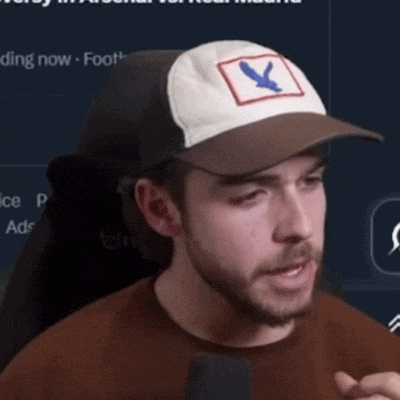 a man wearing a baseball cap with a blue bird on it