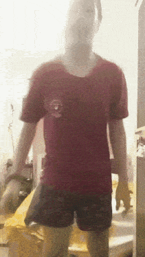 a man in a red shirt with a circle on the chest